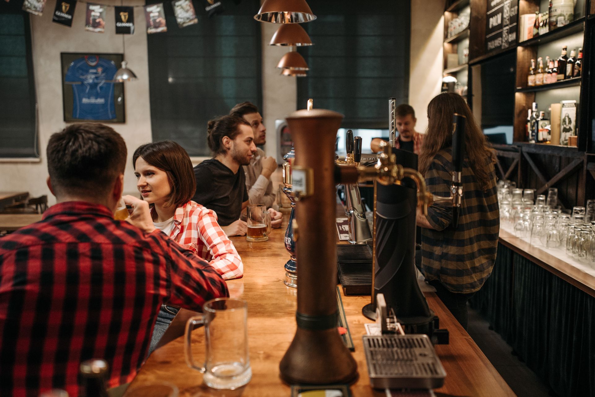 A warm, busy pub interior at service time