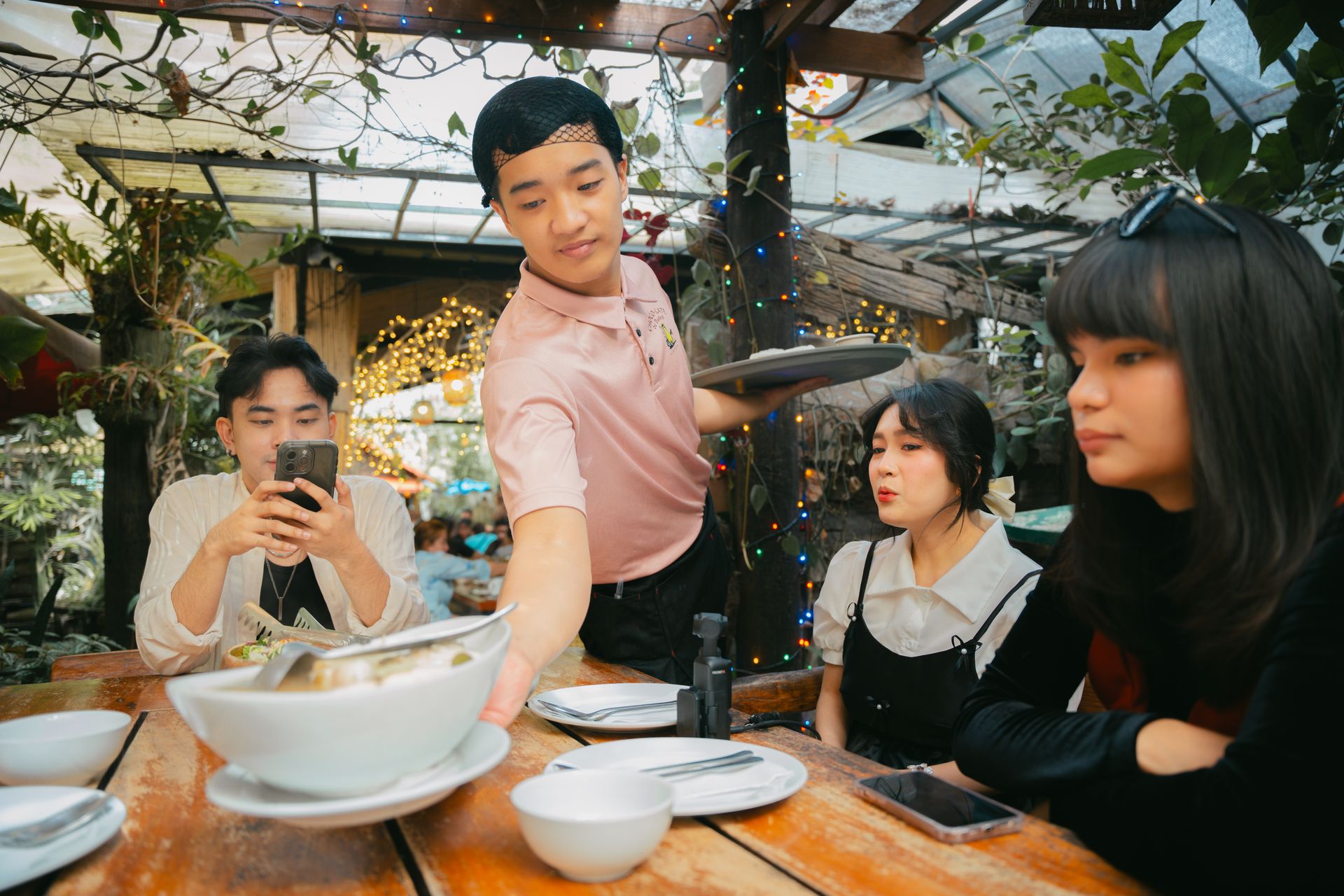 Food arriving at the table, served to happy guests