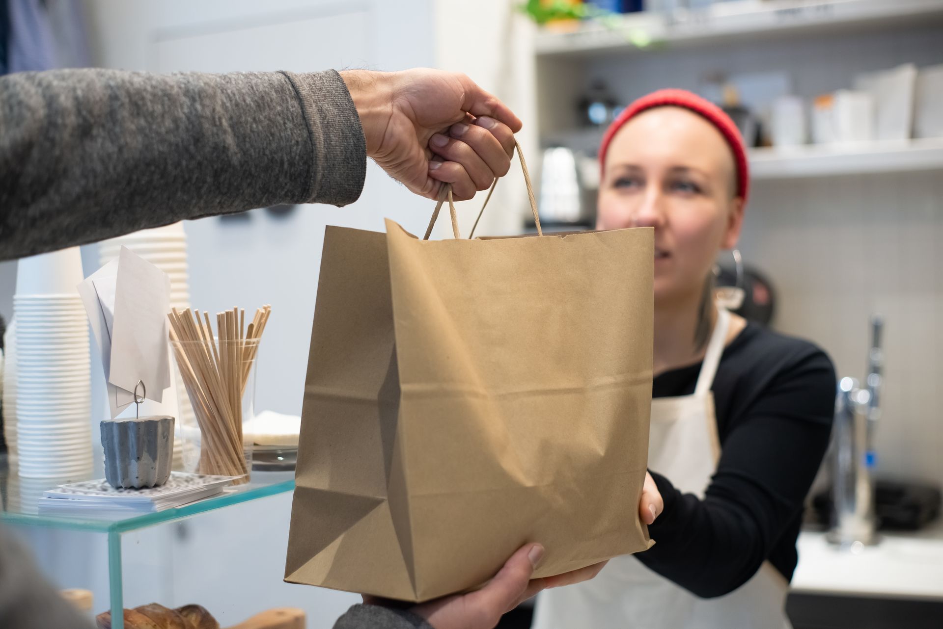 Takeaway order handed over the counter to a waiting customer