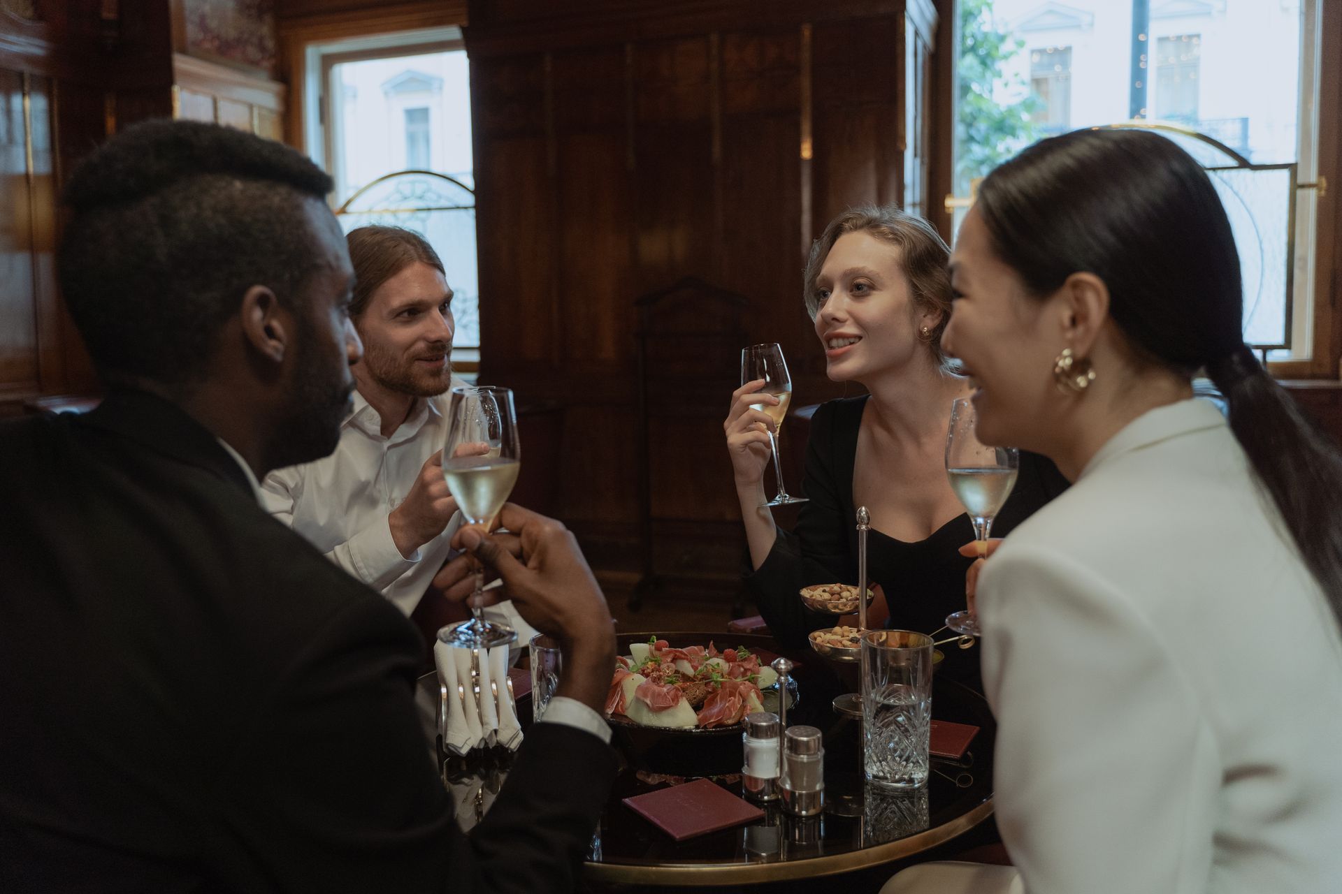 Diners raising a toast over a restaurant table
